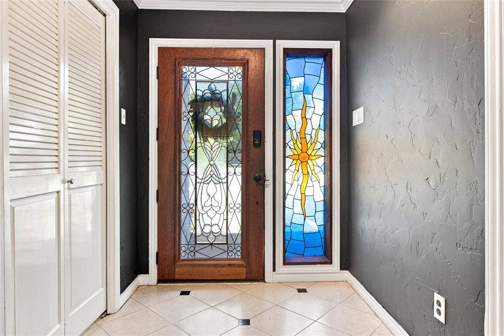 1417 Sun Valley Drive, Garland, TX 75043 Wood-finish entry door with decorative glass inserts and sidelight