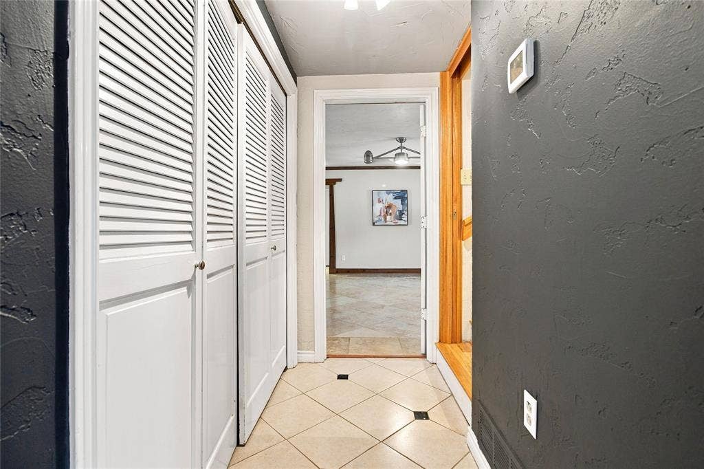 1417 Sun Valley Drive, Garland, TX 75043 Textured wall finish, louvered bi-fold closet doors, tile flooring with decorative inserts, wood door trim, and recessed lighting