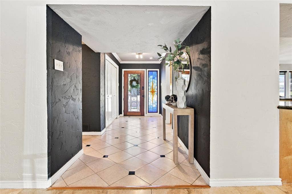1417 Sun Valley Drive, Garland, TX 75043 Entryway featuring tile flooring with dark accent tiles, a wood-panel front door with glass inserts, and a stained-glass sidelight