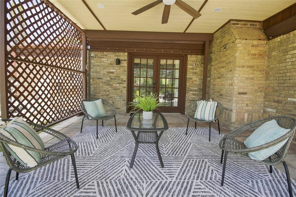 1417 Sun Valley Drive, Garland, TX 75043 Backyard covered patio with ceiling fan, wall, and swimming pool