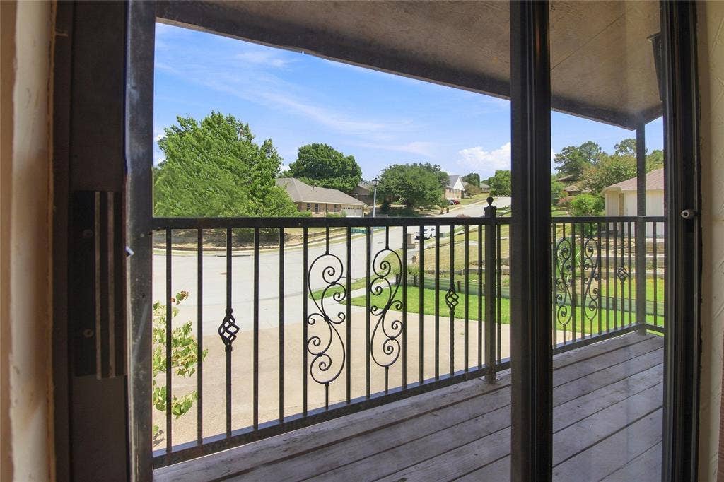 1417 Sun Valley Drive, Garland, TX 75043 Balcony with wood-finish decking and decorative wrought iron railing