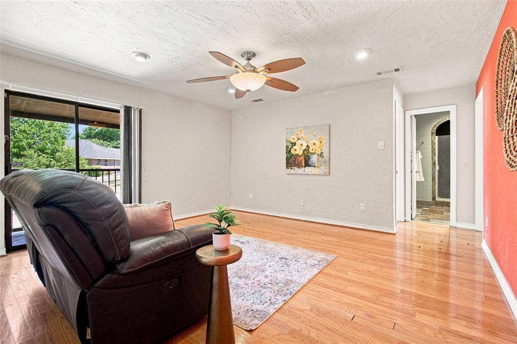 1417 Sun Valley Drive, Garland, TX 75043 Upstairs family room with wood flooring and balcony