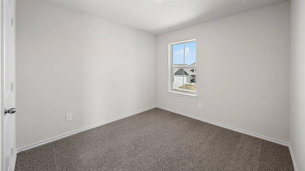 5033 Shumard Drive, Lindale, TX 75771 Gray carpet flooring, white painted walls, white trim, and a white framed window