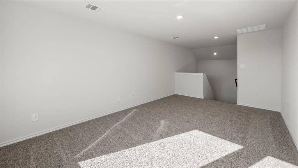 5033 Shumard Drive, Lindale, TX 75771 Spacious room with light gray carpeting, neutral-toned walls, recessed lighting, and a built-in half-wall partition