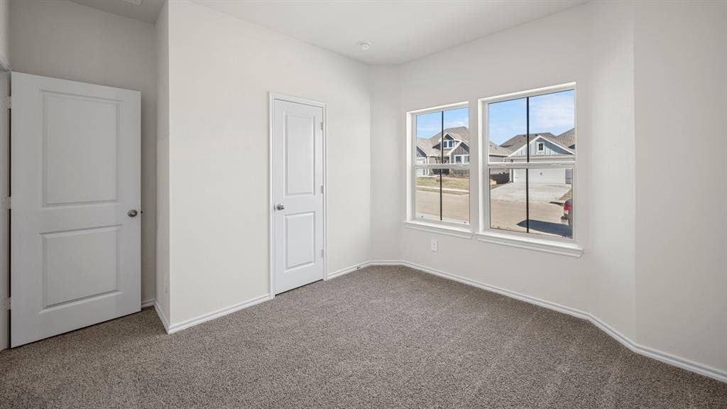 5033 Shumard Drive, Lindale, TX 75771 Neutral wall finishes, two-panel interior doors, and grey carpet flooring