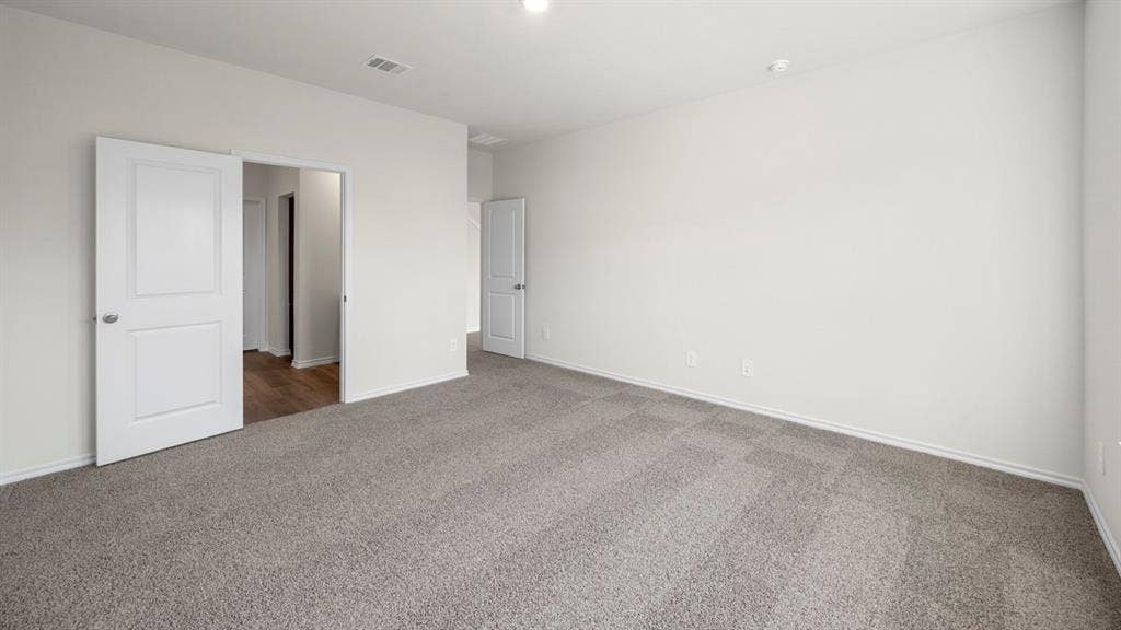 5033 Shumard Drive, Lindale, TX 75771 Expansive room featuring light gray carpet, white walls, recessed lighting, and white interior doors