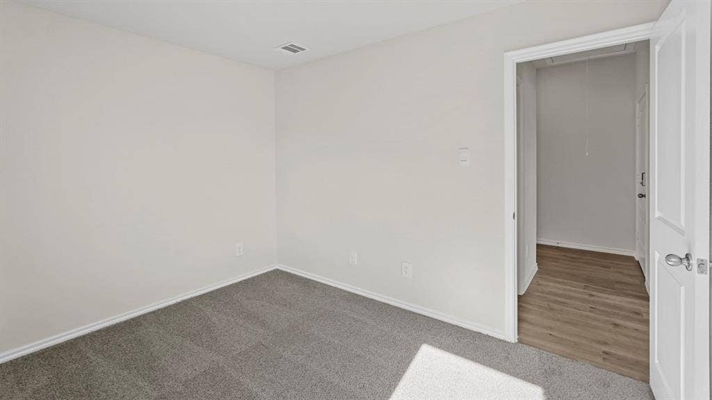 219 Yates Street, Bullard, TX 75757 Light gray carpeting with white baseboards