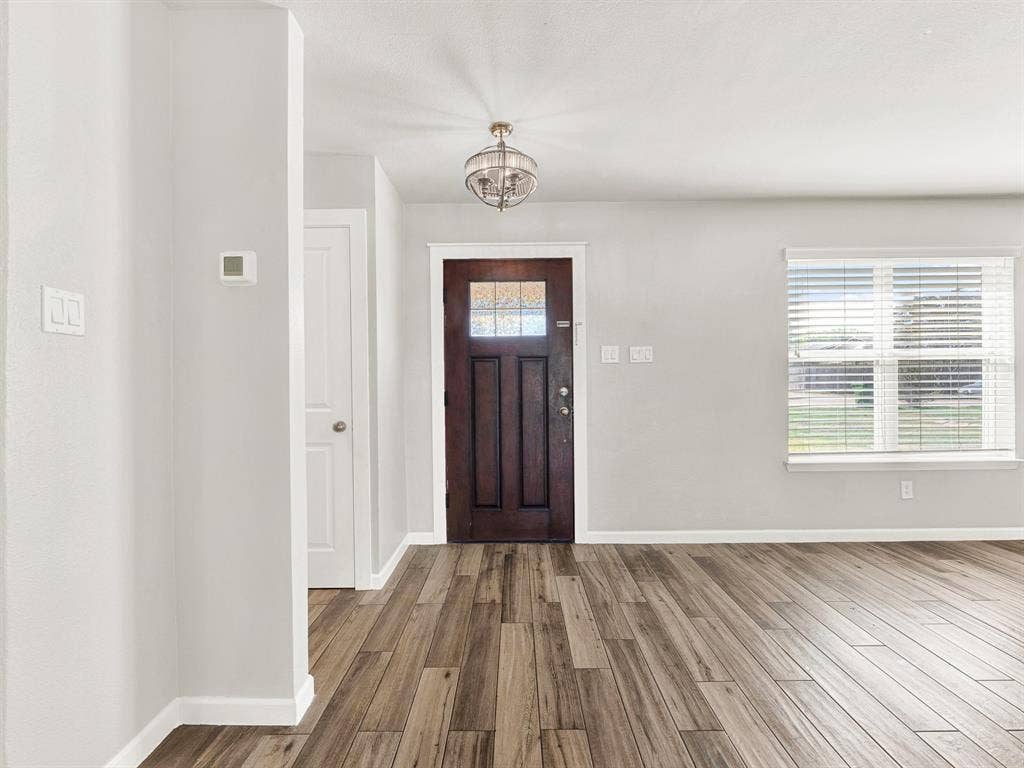 Welcome in!  Durable, low maintenance, wood-look tile in the primary living spaces and fresh paint throughout