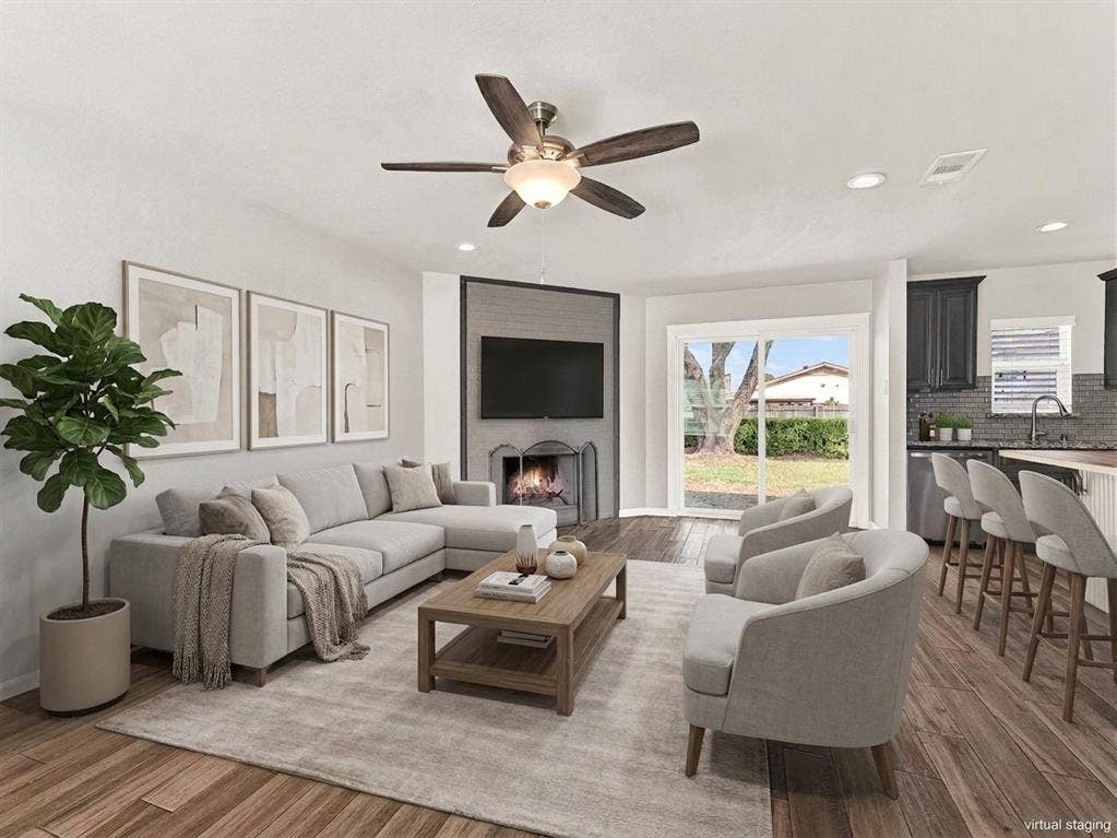 Cozy fireplace and large sliding glass door with a view of your backyard