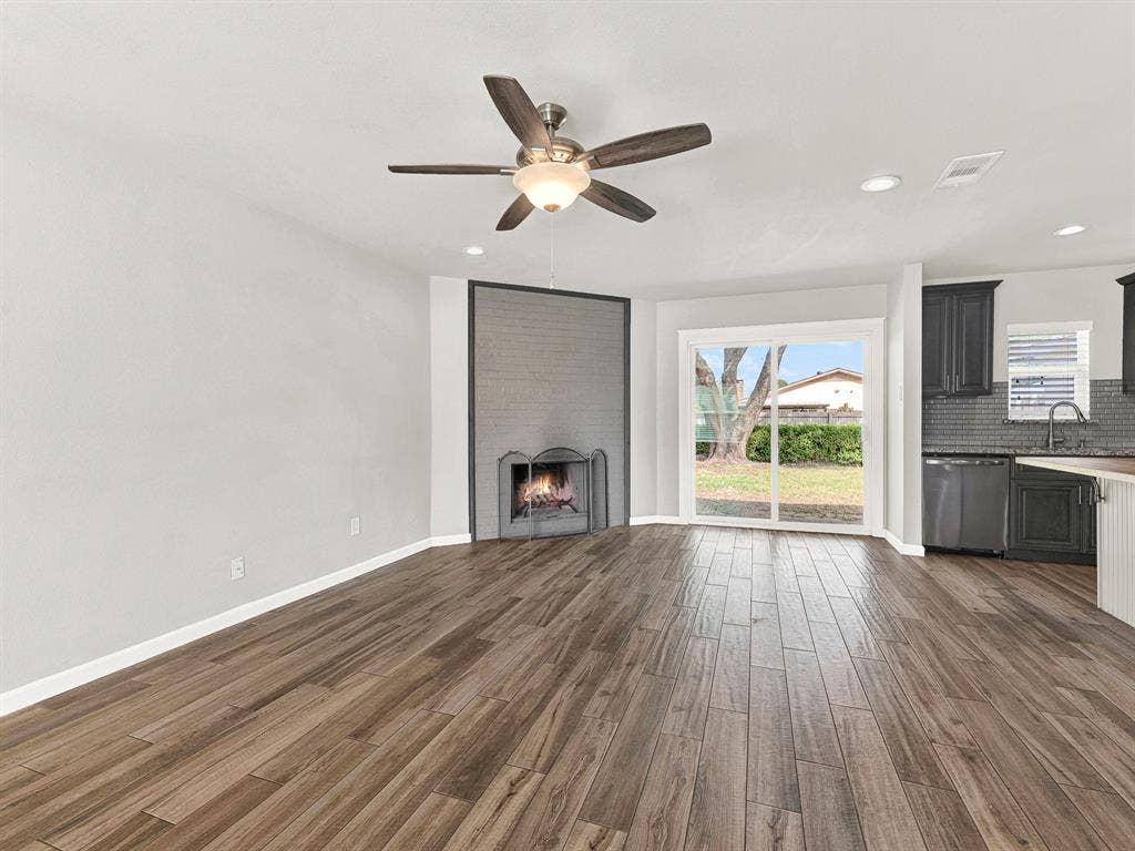 Cozy fireplace and large sliding glass door with a view of your backyard