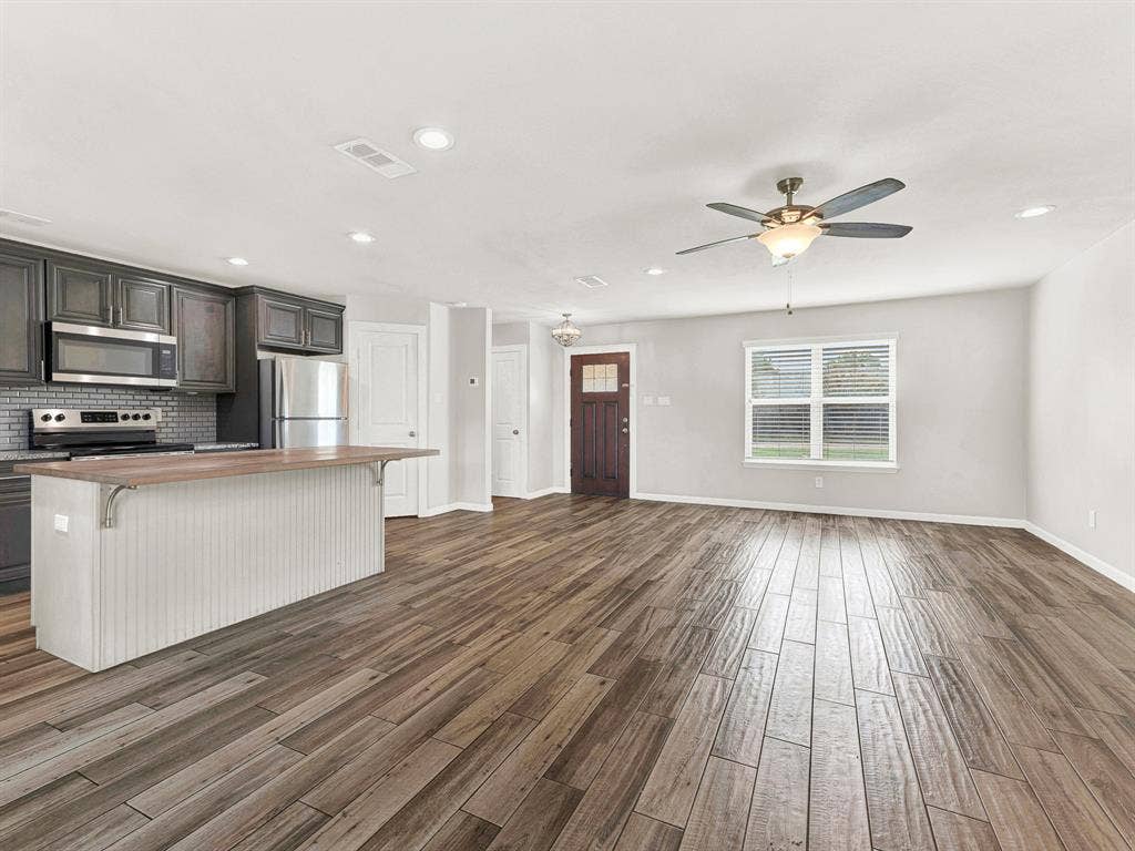 Open concept living at it's best- living room, kitchen, breakfast bar, and dining area