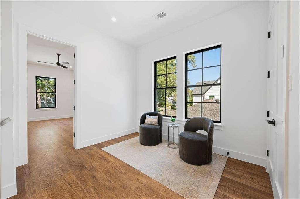 4320 Concho Street, Dallas, TX 75206 Expansive room featuring wood-finish flooring, white walls, and multiple grid-pattern windows