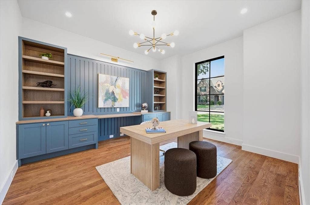 4320 Concho Street, Dallas, TX 75206 Hardwood-finish flooring, built-in cabinetry, integrated desk space, decorative wall paneling, and an expansive window