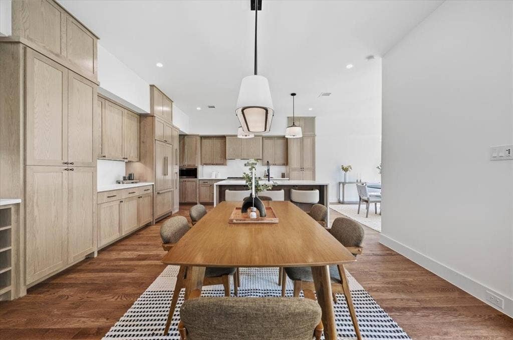 4320 Concho Street, Dallas, TX 75206 Wood-finish flooring throughout, modern pendant lighting, white walls, and extensive light wood-finish cabinetry