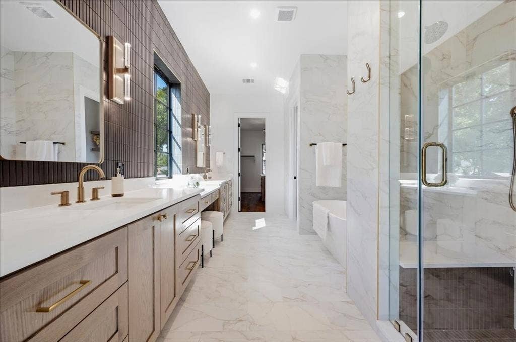 4320 Concho Street, Dallas, TX 75206 Double vanity with integrated sinks, wood-finish cabinetry, and brass hardware