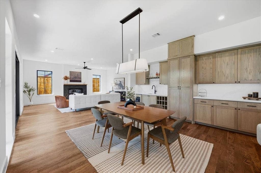 4320 Concho Street, Dallas, TX 75206 Hardwood flooring throughout, built-in dry bar with wine storage, recessed lighting, and a modern linear chandelier