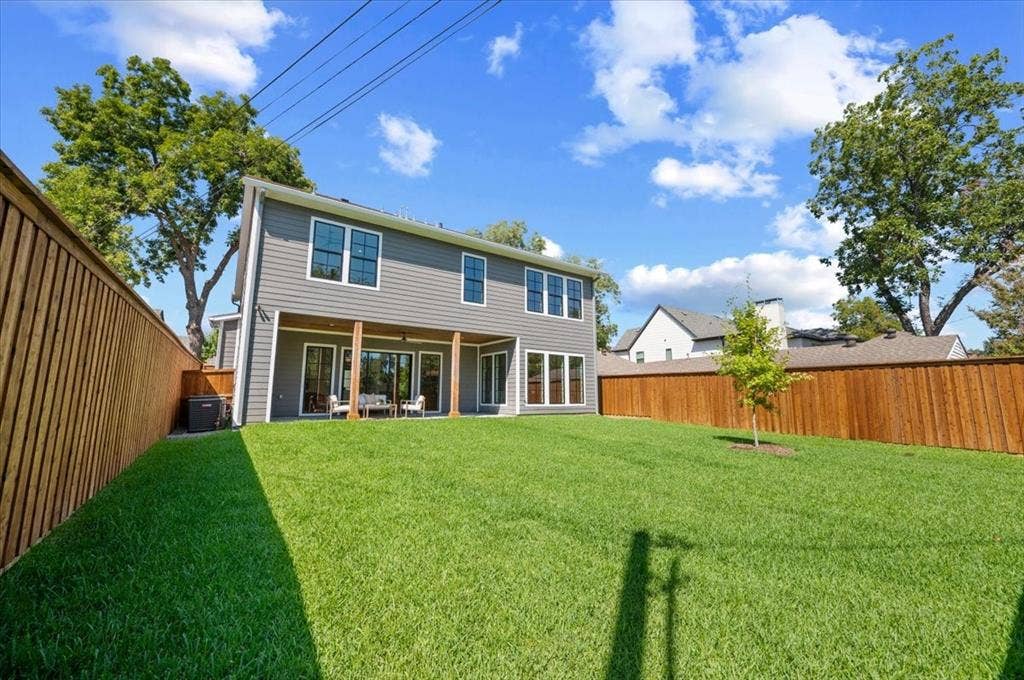 4320 Concho Street, Dallas, TX 75206 Spacious green lawn with a newly installed wood privacy fence