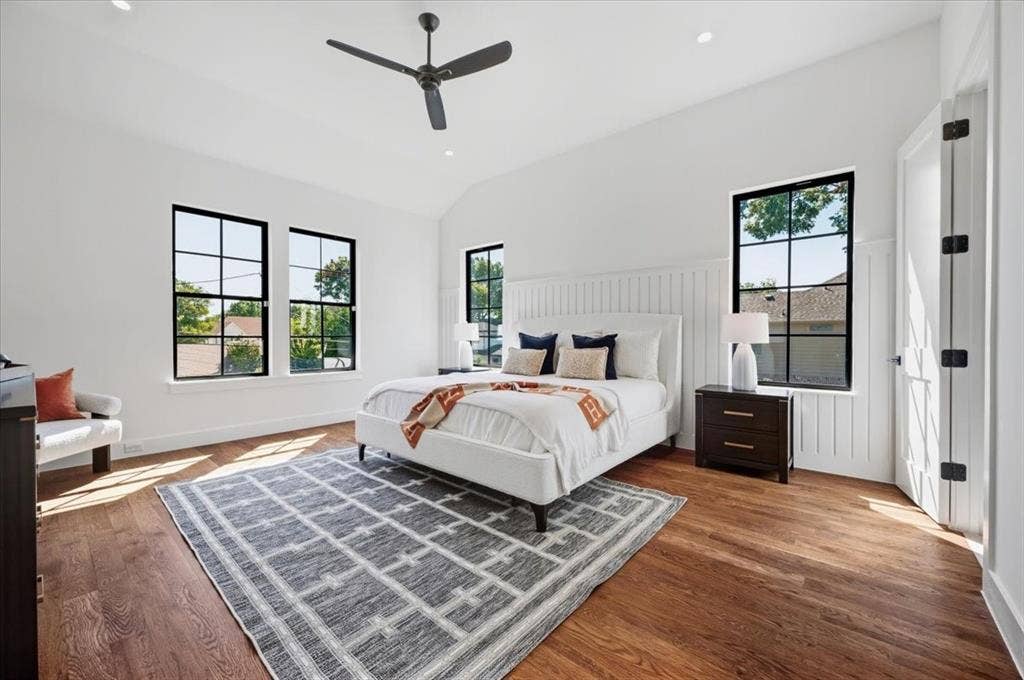 4320 Concho Street, Dallas, TX 75206 Vaulted ceiling with a black ceiling fan, dark wood-finish flooring, white walls, and black-framed windows