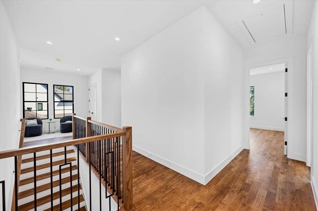 4320 Concho Street, Dallas, TX 75206 Hardwood flooring throughout, modern black-framed windows, recessed ceiling lighting, and a contemporary stair railing with wood newel posts