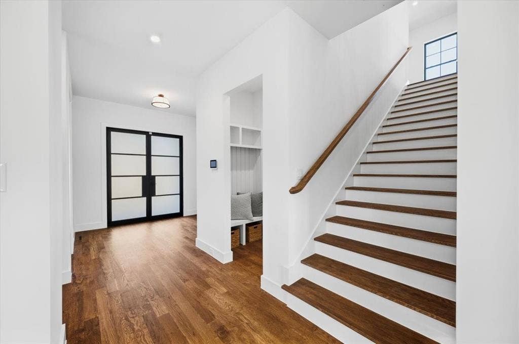 4320 Concho Street, Dallas, TX 75206 Hardwood-finish flooring, built-in cabinetry, integrated desk space, decorative wall paneling, and an expansive window