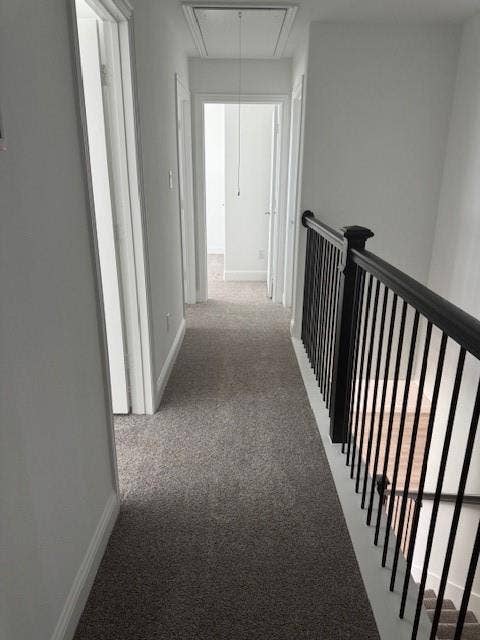 109 North Sky Drive, Celina, TX 75009 Carpeted hallway featuring a black metal railing and white trim