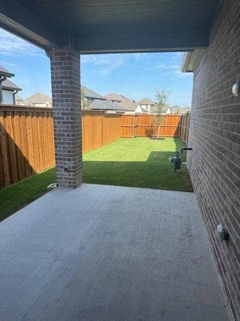 109 North Sky Drive, Celina, TX 75009 Covered concrete patio with a brick support column