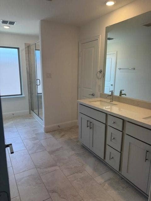 109 North Sky Drive, Celina, TX 75009 Dual sink vanity with light-toned countertop, glass-enclosed shower, light-toned tile flooring, and recessed lighting