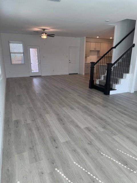 109 North Sky Drive, Celina, TX 75009 Open-concept living area featuring wood-finish flooring, a ceiling fan, and a glass-paneled exterior door with side window