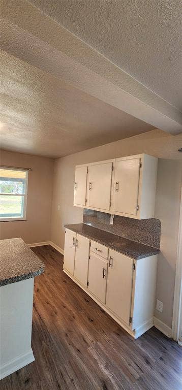 2016 Gavin Road, Tool, TX 75143 Vinyl flooring, white cabinetry, speckled countertops, and a single window