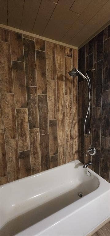 2016 Gavin Road, Tool, TX 75143 Bathtub with a chrome shower fixture, a handheld showerhead, and tile
