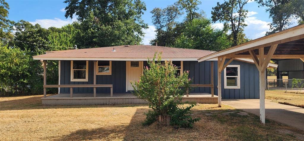 2016 Gavin Road, Tool, TX 75143 Blue siding exterior with a covered front porch, white-trimmed windows, and an attached carport