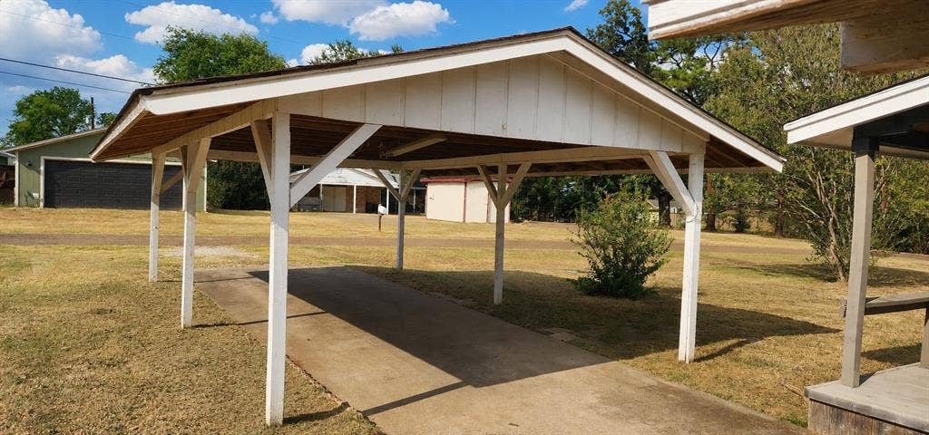 2016 Gavin Road, Tool, TX 75143 Covered carport with a concrete driveway and exposed wood rafter ceiling
