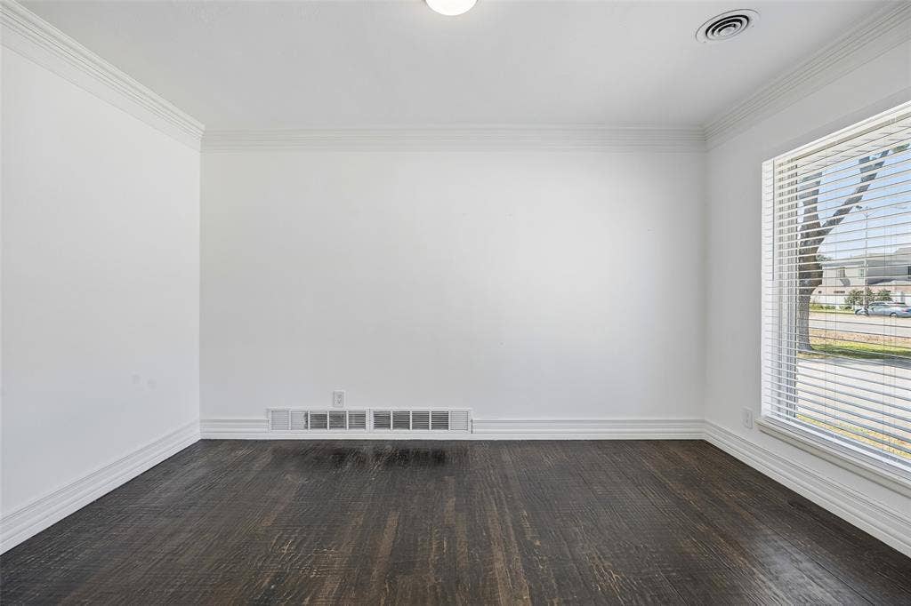 5610 Forest Lane, Dallas, TX 75230 Dark wood-finish flooring with white baseboards and crown molding