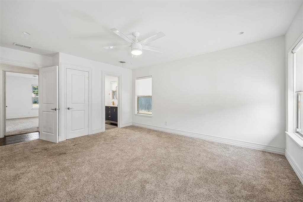 5610 Forest Lane, Dallas, TX 75230 Wall-to-wall carpeting with natural light from multiple windows