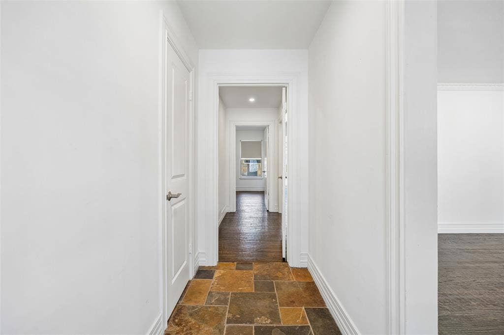 5610 Forest Lane, Dallas, TX 75230 Hallway featuring multi-toned slate flooring and white trim