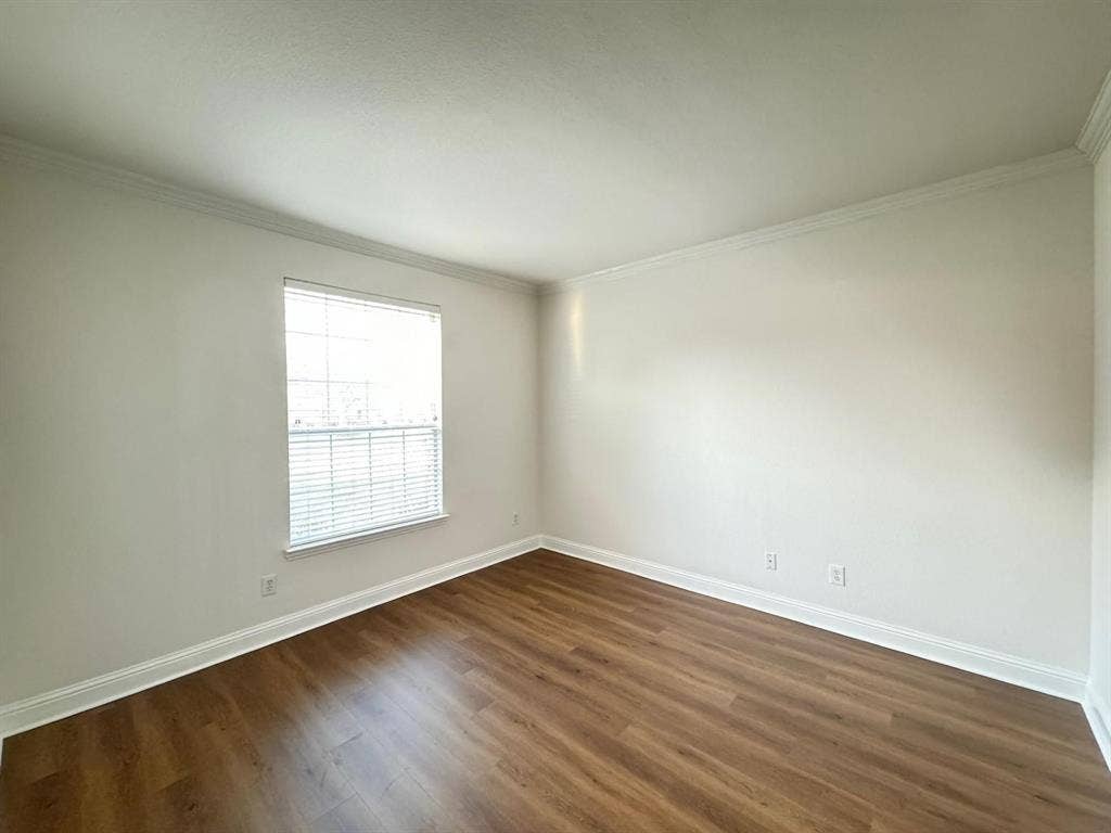 4531 Oak Shores Drive, Plano, TX 75024 Wood-finish flooring, white walls, and a window with horizontal blinds