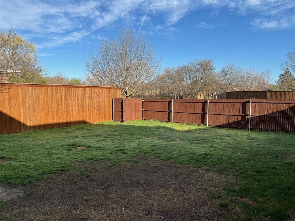 4531 Oak Shores Drive, Plano, TX 75024 Fenced backyard with a combination of light wood-tone and dark wood-tone privacy fencing