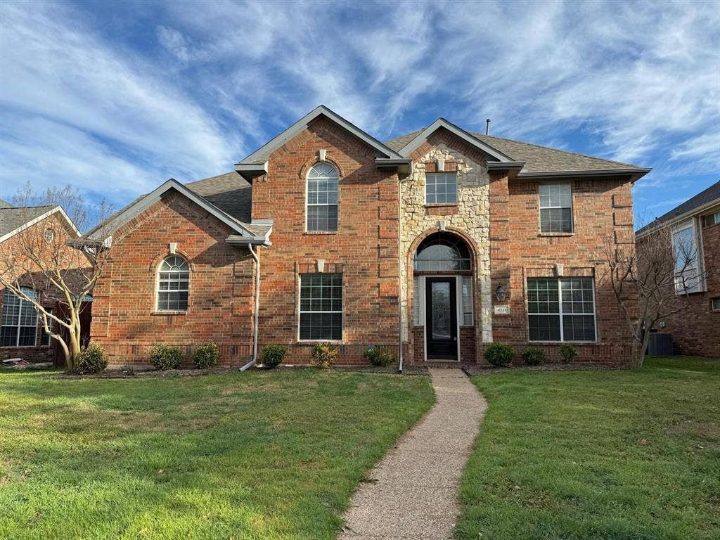 4531 Oak Shores Drive, Plano, TX 75024 Brick exterior with stone accents, arched entryway, gabled roofline, and established front landscaping