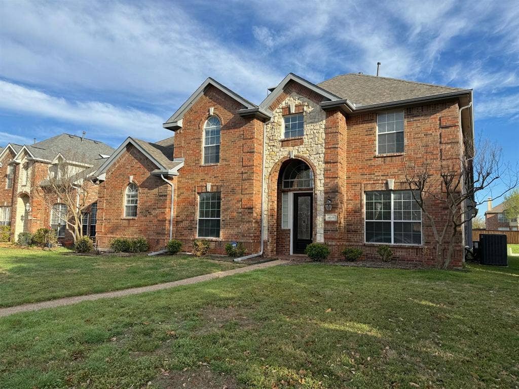 4531 Oak Shores Drive, Plano, TX 75024 Brick exterior with stone accents, arched entryway, and multiple gables