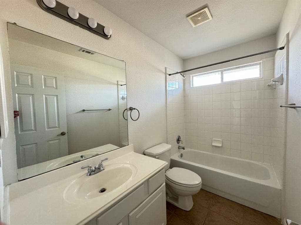 4531 Oak Shores Drive, Plano, TX 75024 Bathroom with a single vanity, large mirror, and full-size tub with overhead shower