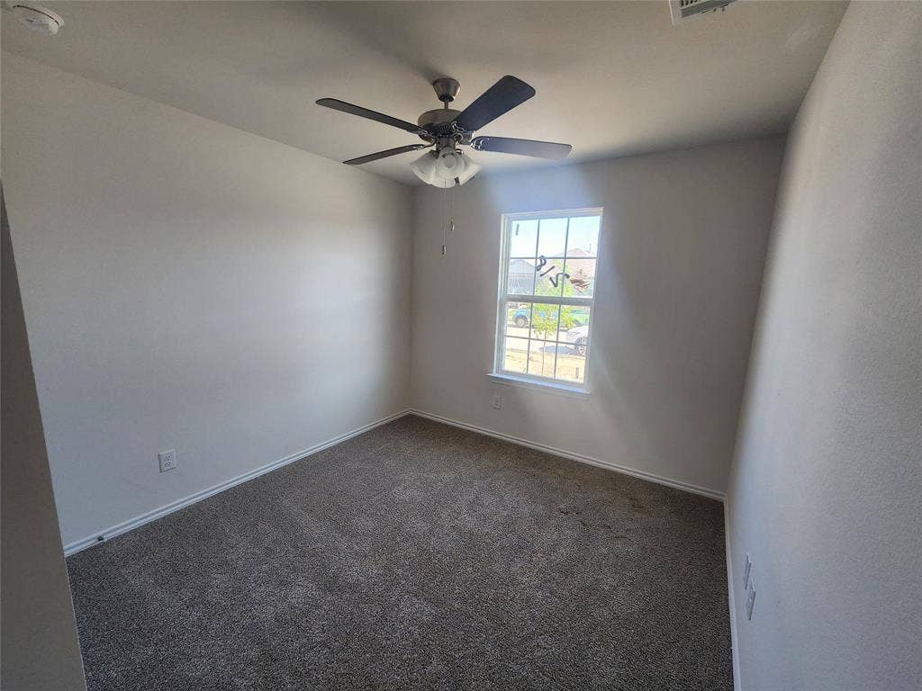 1302 Breezy Oak Drive, Nevada, TX 75173 Carpeted flooring with a ceiling fan and a window