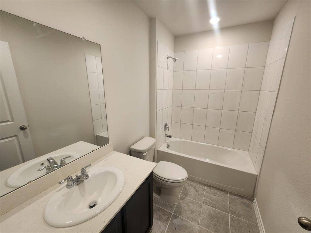 1302 Breezy Oak Drive, Nevada, TX 75173 White vanity with an integrated sink, polished chrome faucet, and a large wall-mounted mirror