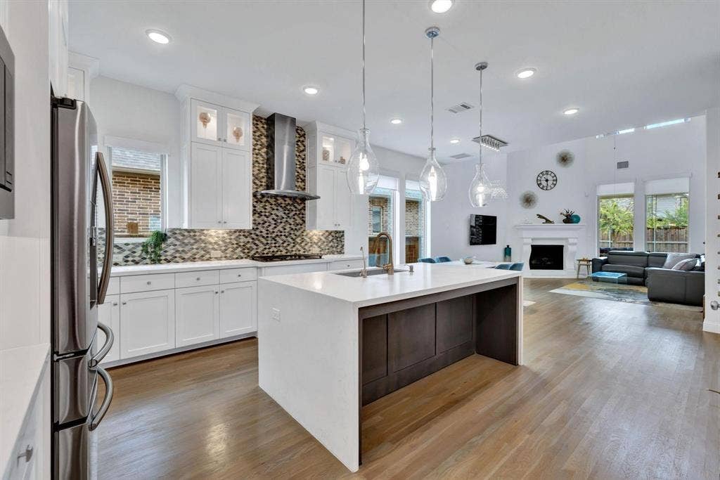 625 Quarter Horse Lane, Frisco, TX 75036 Kitchen with a large central island, white cabinetry, and a patterned backsplash