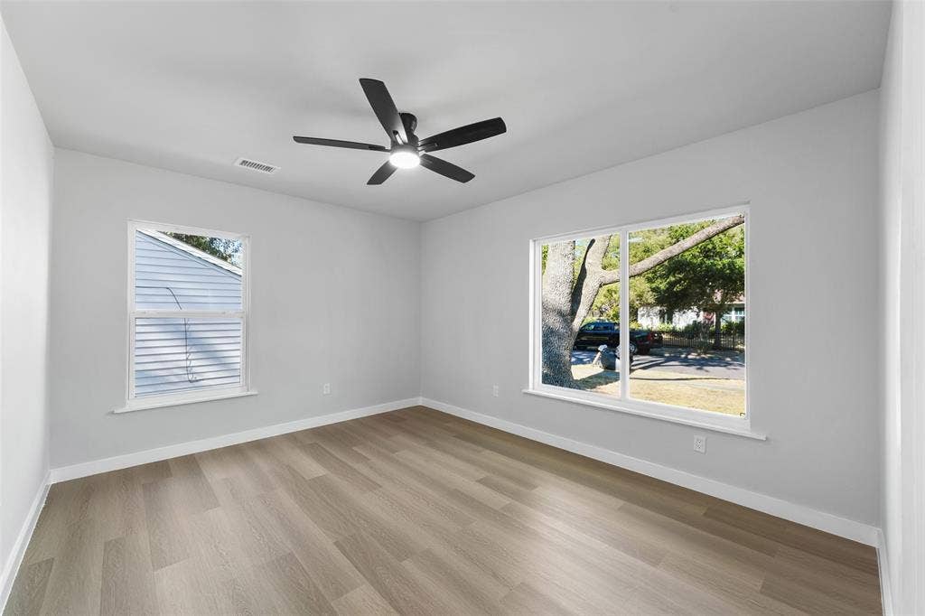Recessed ceiling fan, wood-finish flooring, and multiple windows