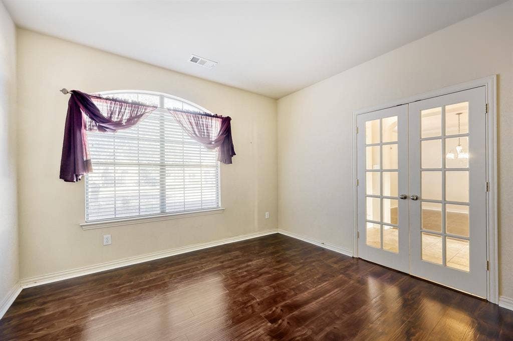 1012 Surrey Drive, DeSoto, TX 75115 Vaulted ceiling, arched window, wood-finish flooring, white trim, and French doors