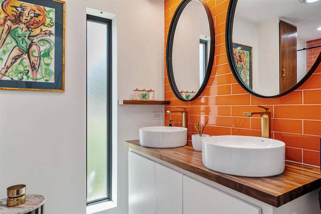105 Azalea Court, Trinidad, TX 75163 vibrant color, double sink vanity, penny white tile floors, and floating cabinet