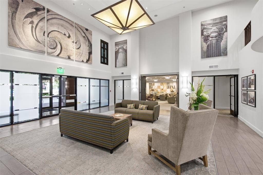 330 Las Colinas Boulevard E, #1216, Irving, TX 75039 Open-concept reception area featuring high ceilings, wood-finish flooring, and large glass panel walls