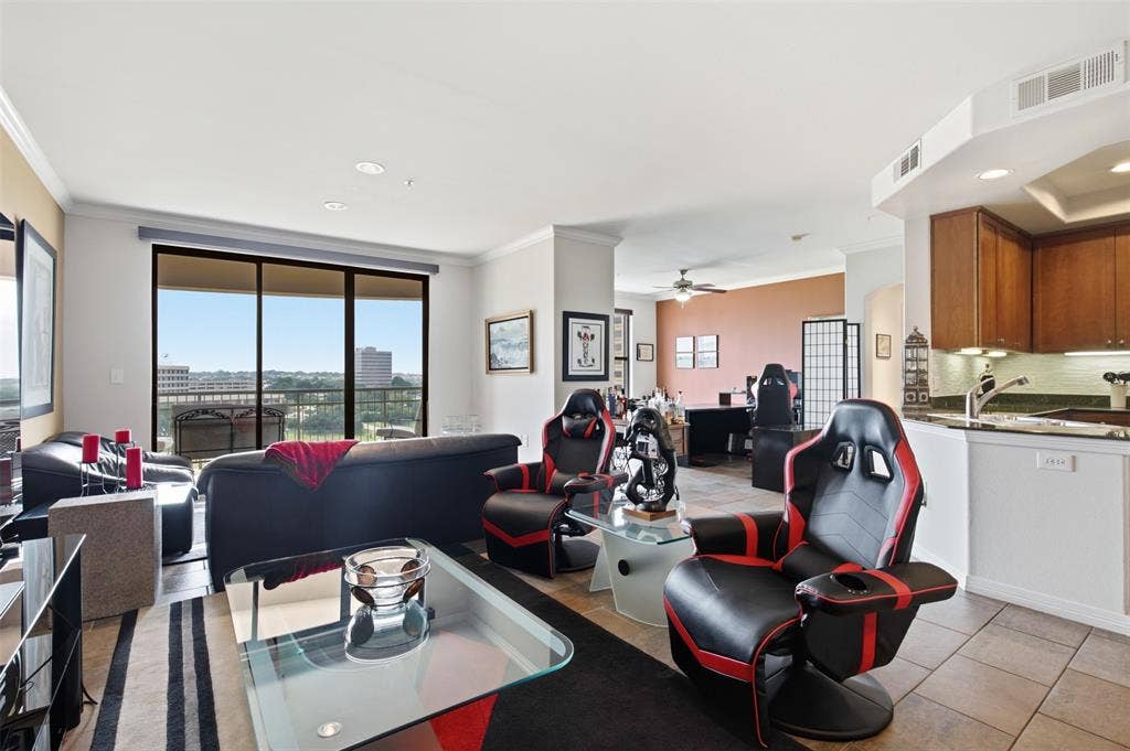 330 Las Colinas Boulevard E, #1216, Irving, TX 75039 Open-concept living area with large sliding glass doors, recessed lighting, crown molding, and tiled flooring extending into the kitchen