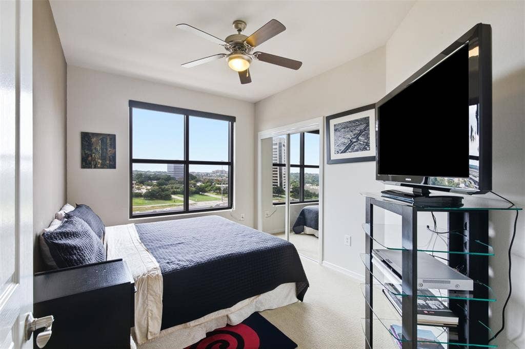 330 Las Colinas Boulevard E, #1216, Irving, TX 75039 Large window with exterior scenery, ceiling fan with integrated lighting, mirrored sliding closet doors, and carpeted flooring