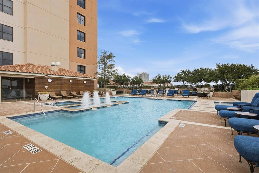 330 Las Colinas Boulevard E, #1216, Irving, TX 75039 Spacious outdoor pool deck featuring a swimming pool, integrated spa, and fountains